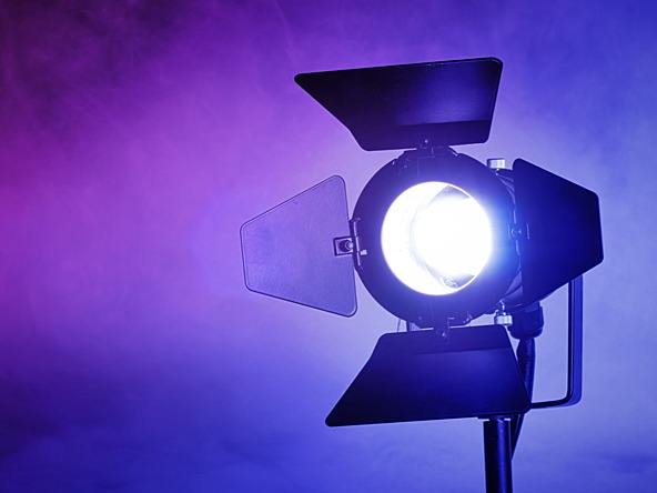 shining spotlight against a purple background